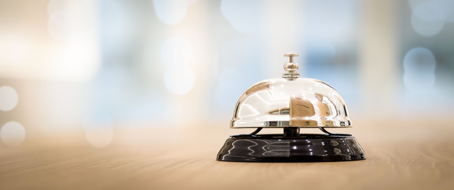 Metal service bells on wooden floor Service concept and customer assistance.